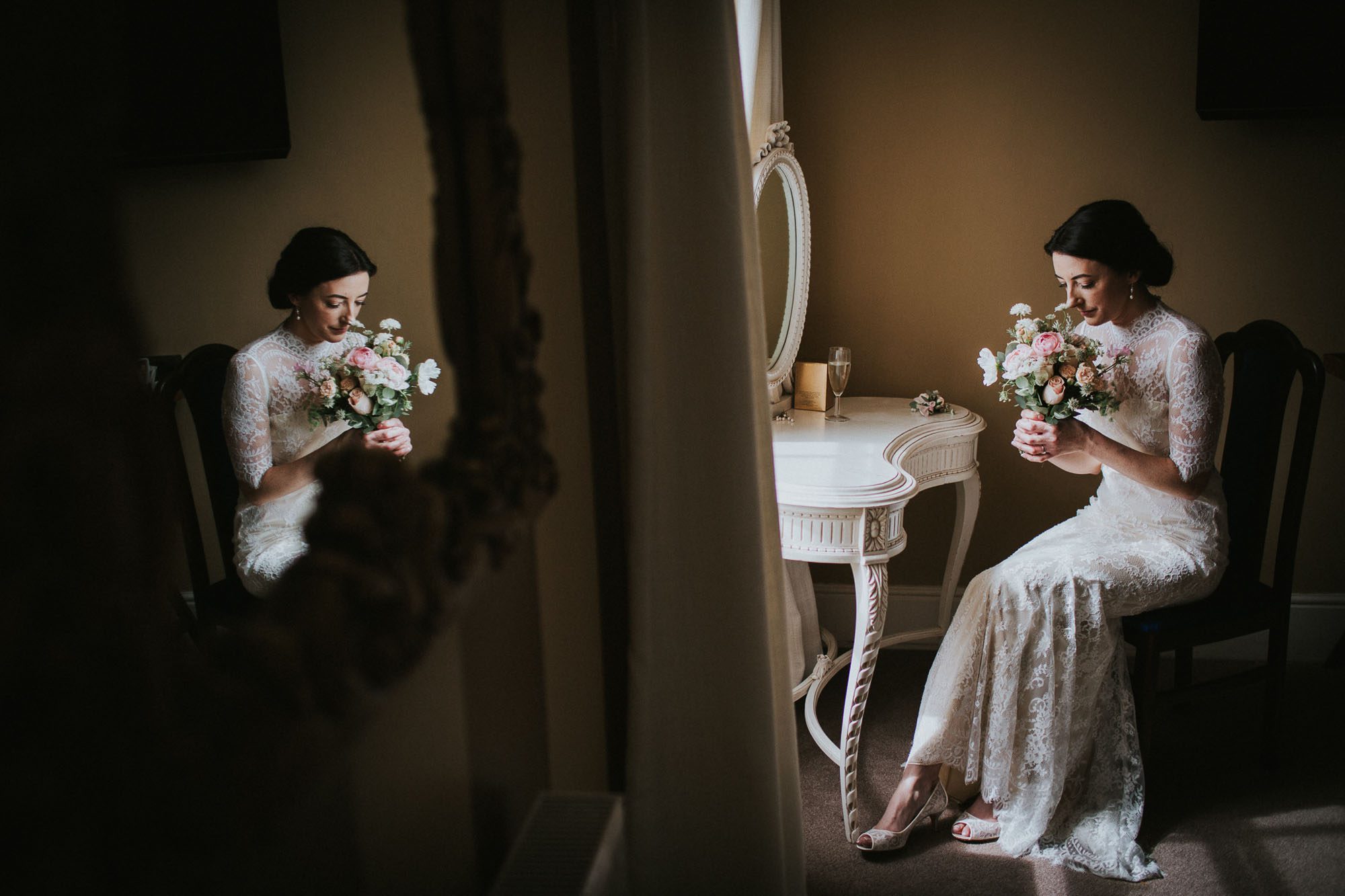 Bride sat down at dressing table. Reflected in the mirror. sniffing bouquet. Elegant portrait