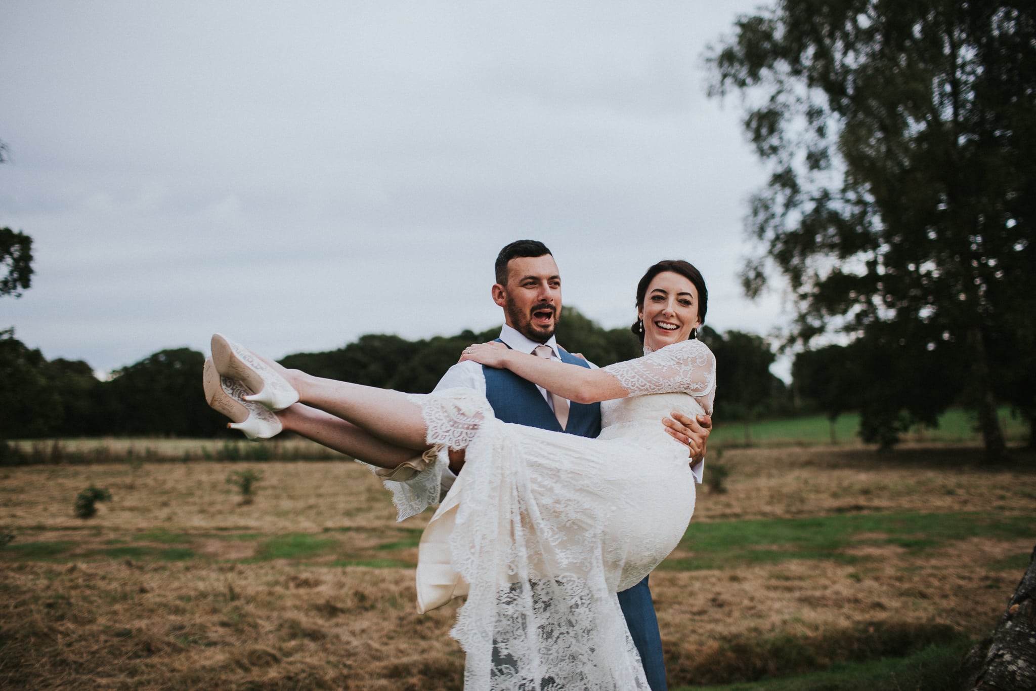 Groom carries bride at East Close Country Hotel