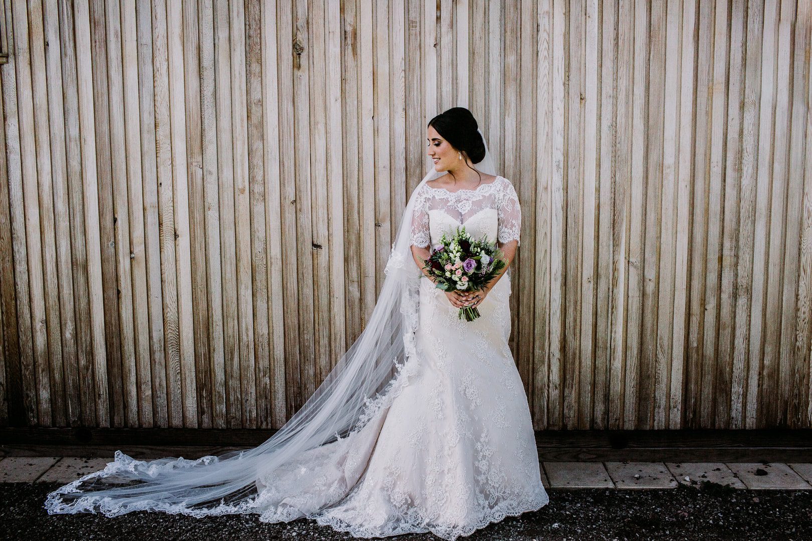 Wedding Photography at Thoresby Riding Hall - bridal portrait outside the cabins at Sherwood Forest Hideaway.