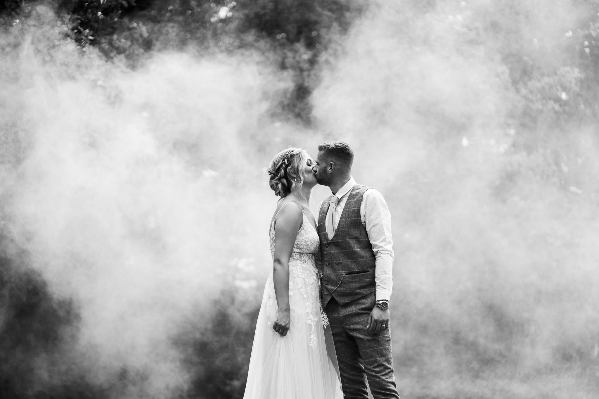 Wedding Photography at Cockliffe House - couple kissing in smoke of smoke bomb