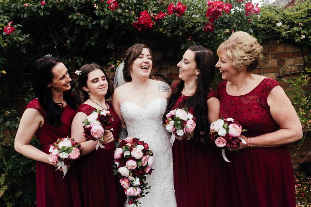 Bride laughing with bridesmaids