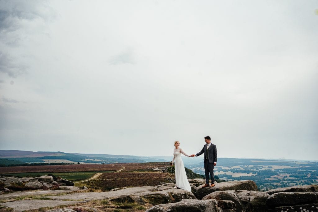 Couple walking on the rocks at Curbar Edge