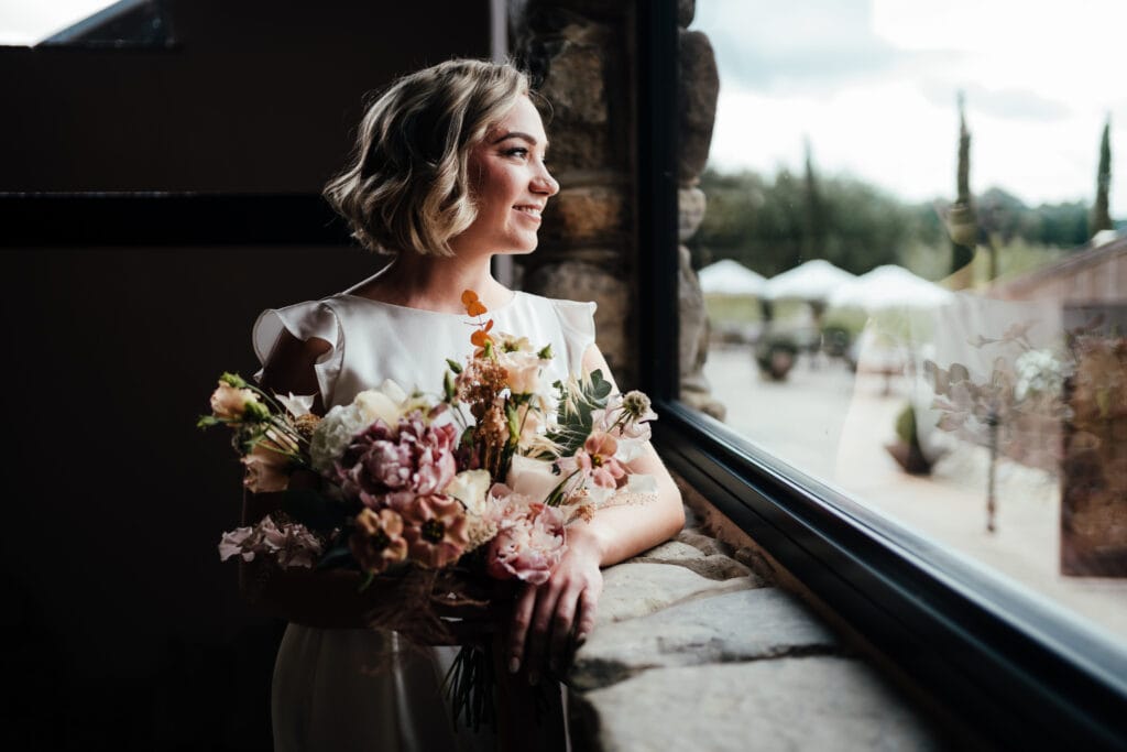 Bride looking out of window at Willow Marsh Farm