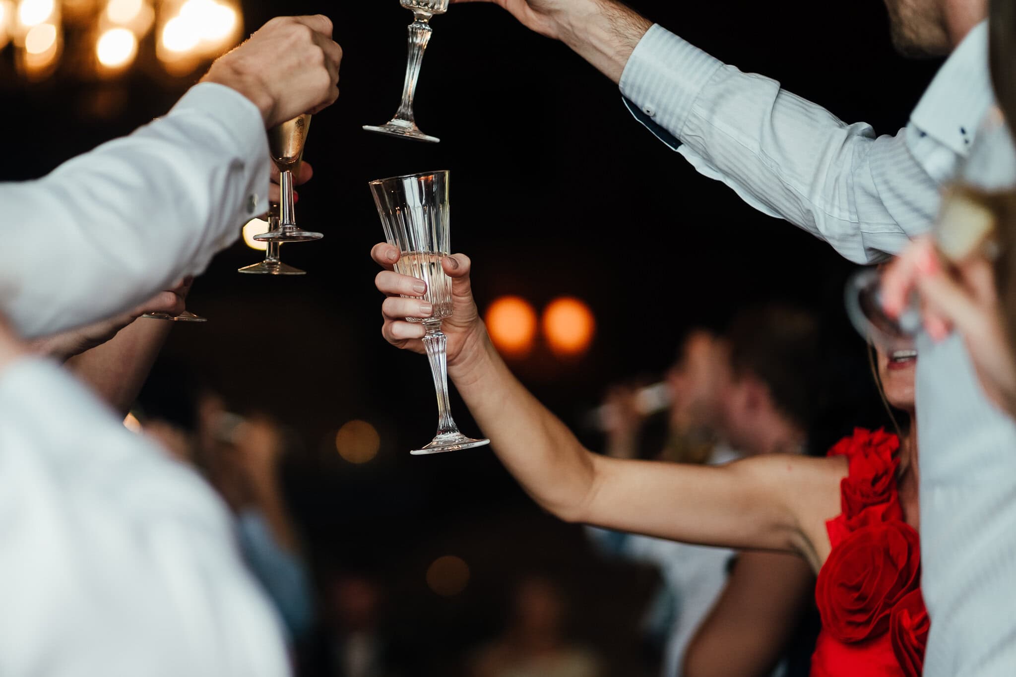 hands holding champagne glasses